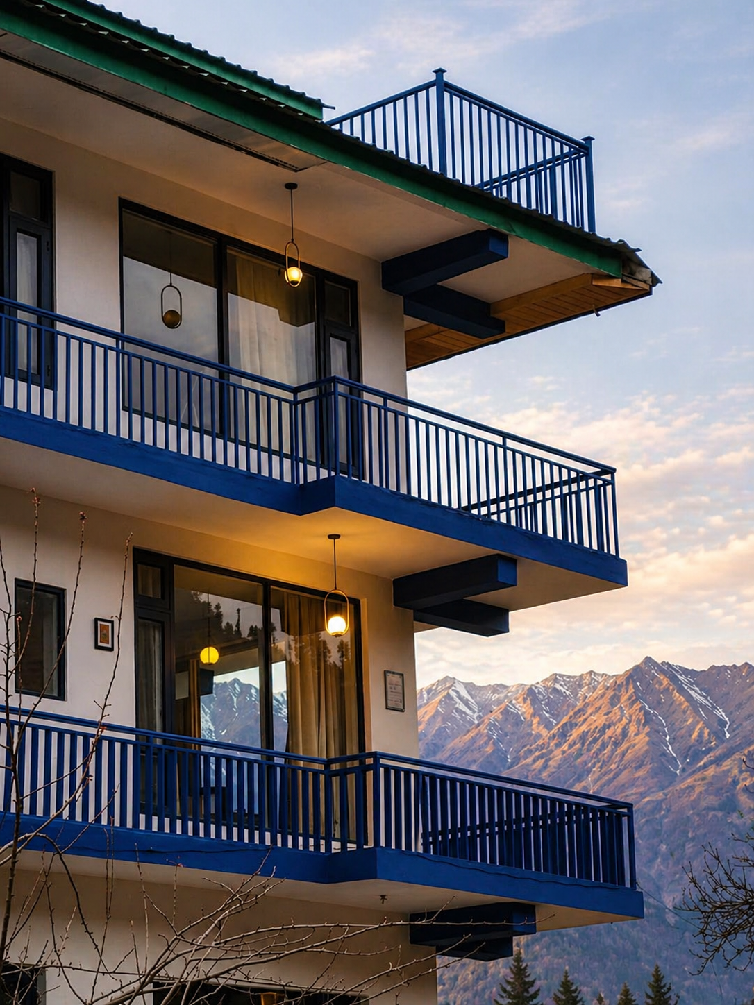 Curious Cat Cottage — blue building with Himalayan peaks