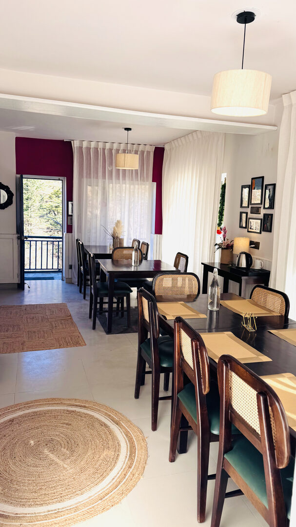 Dining room — rattan chairs, pendant lights, berry-pink curtains