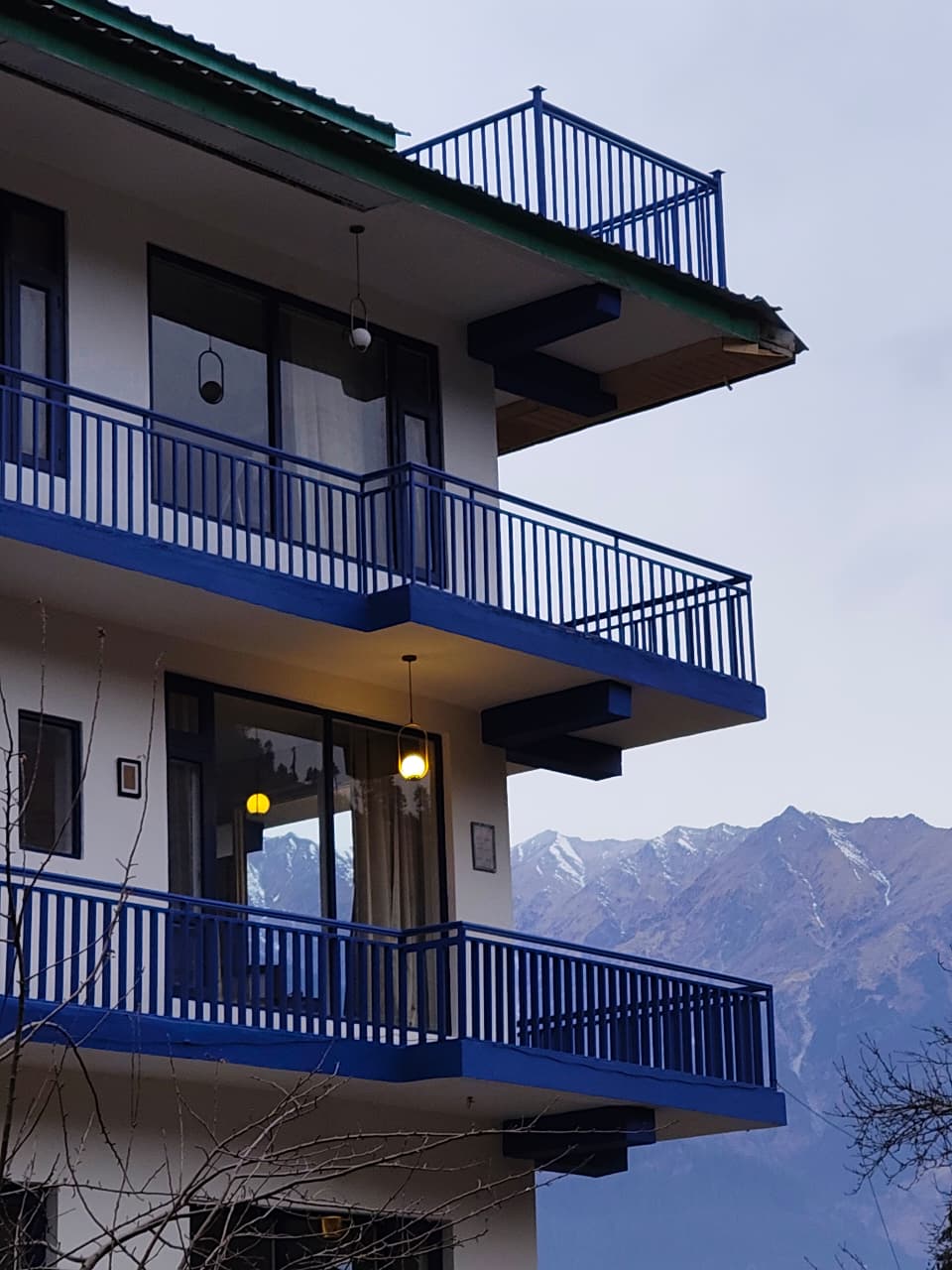 Blue building with Himalayan peaks