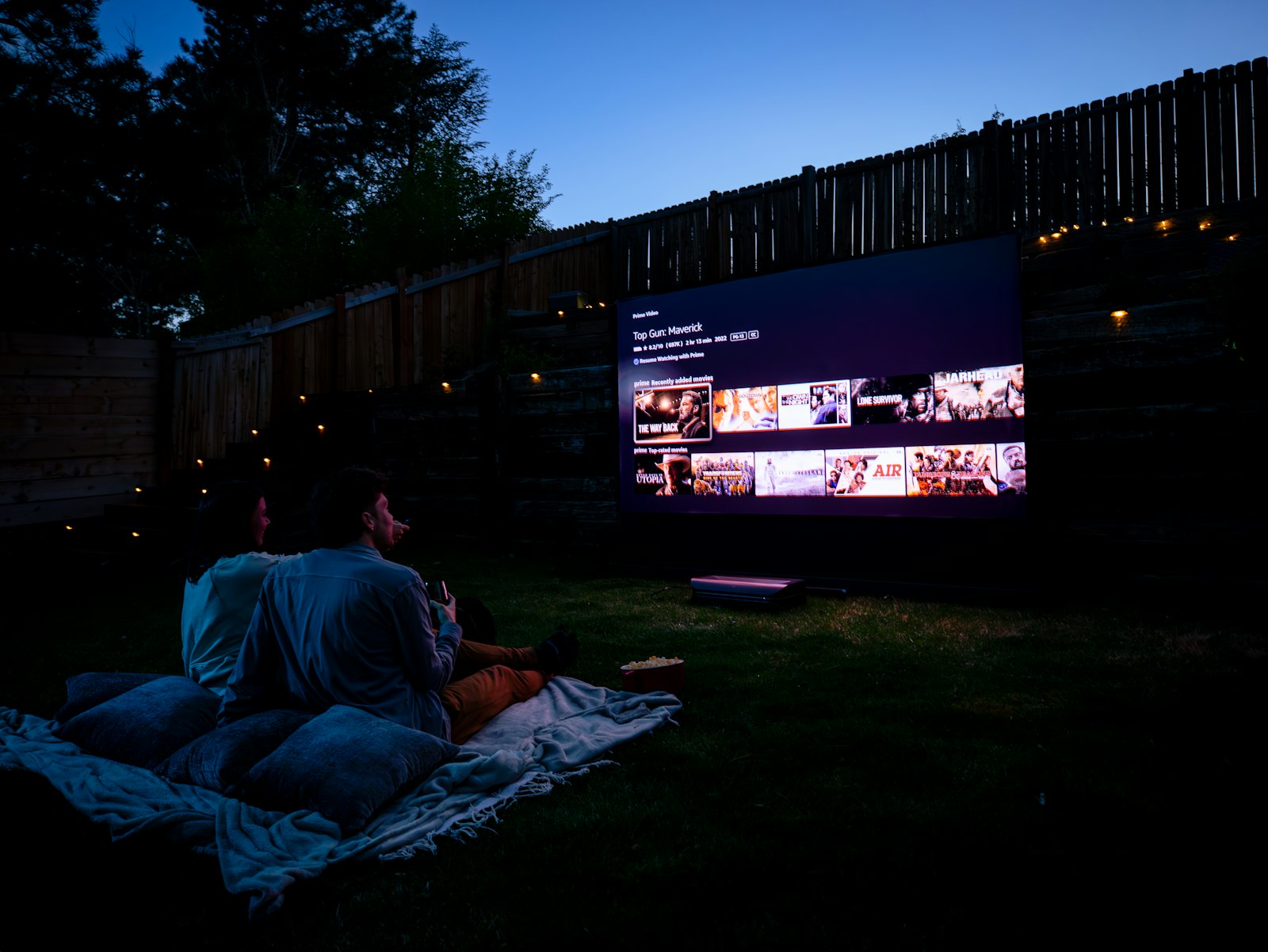 Outdoor cinema on blankets at dusk