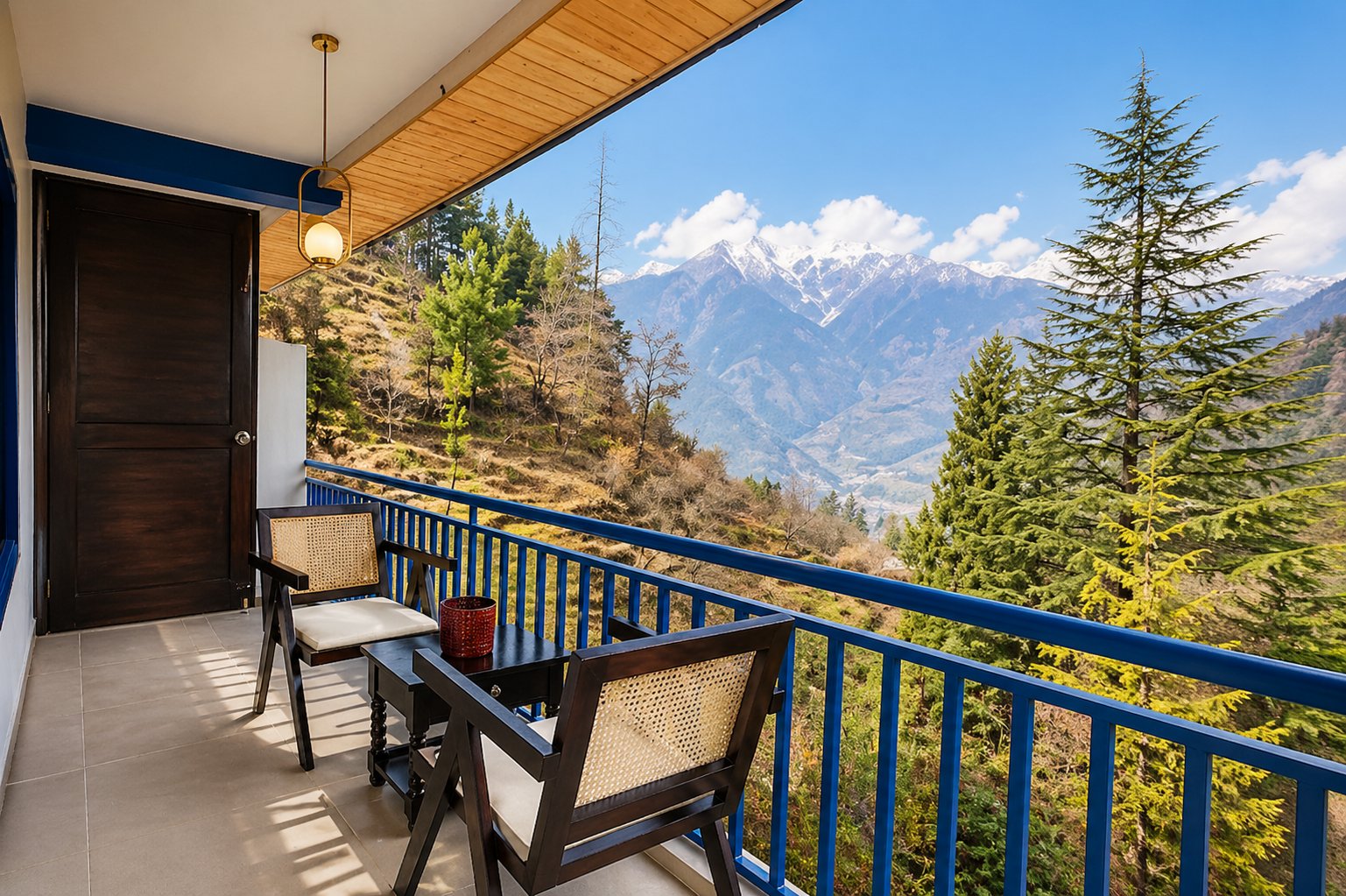 Private balcony seating with a Himalayan mountain view at Curious Cat Cottage, Naggar