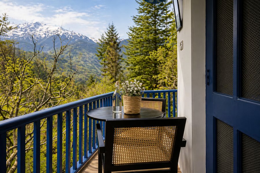 Custom table and cane chairs on a private balcony overlooking the Himalayas